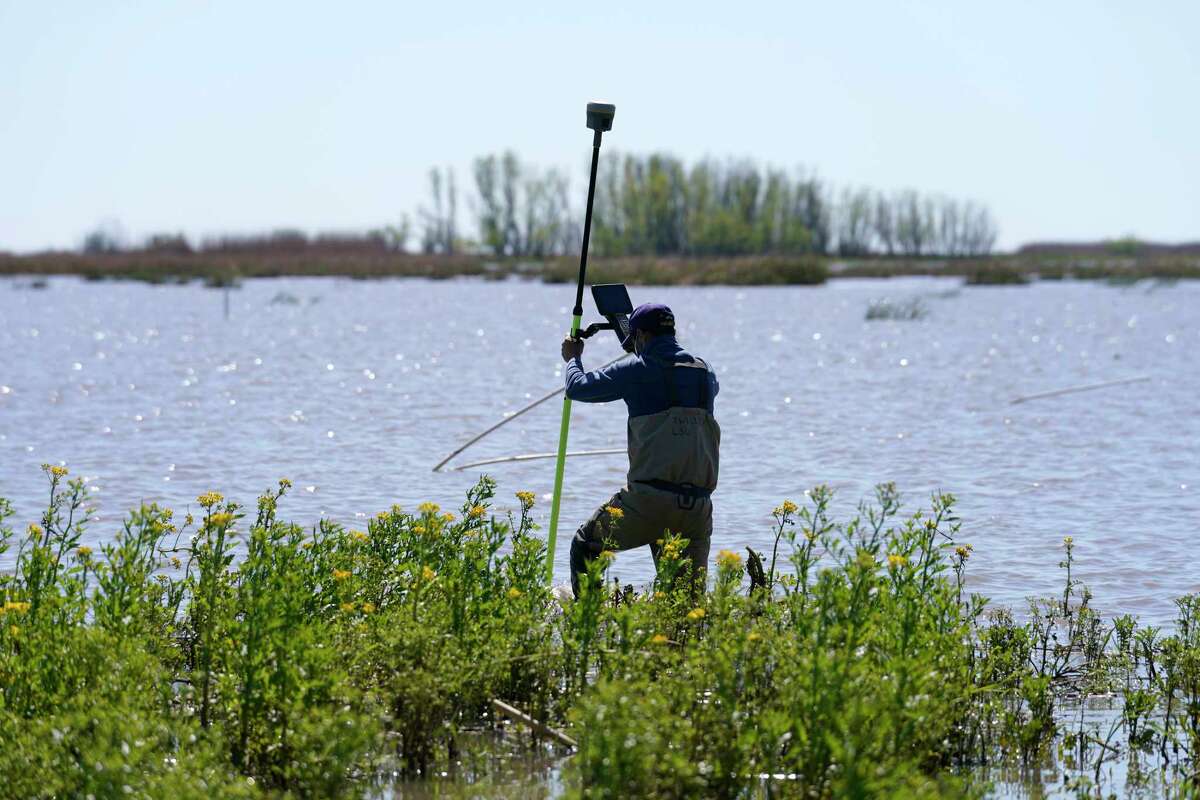 Andre Rabay, research scientist for the LSU Department of Oceanography and Coastal Science uses a real time kinetic (RTK) GPS to take measurements on Mike Island, part of the Wax Lake Delta in the Atchafalaya Basin, in St. Mary Parish, La., Friday, April 2, 2021. NASA is using high-tech airborne systems along with boats and mud-slogging work on islands for a $15 million study of these two parts of Louisiana's river delta system.