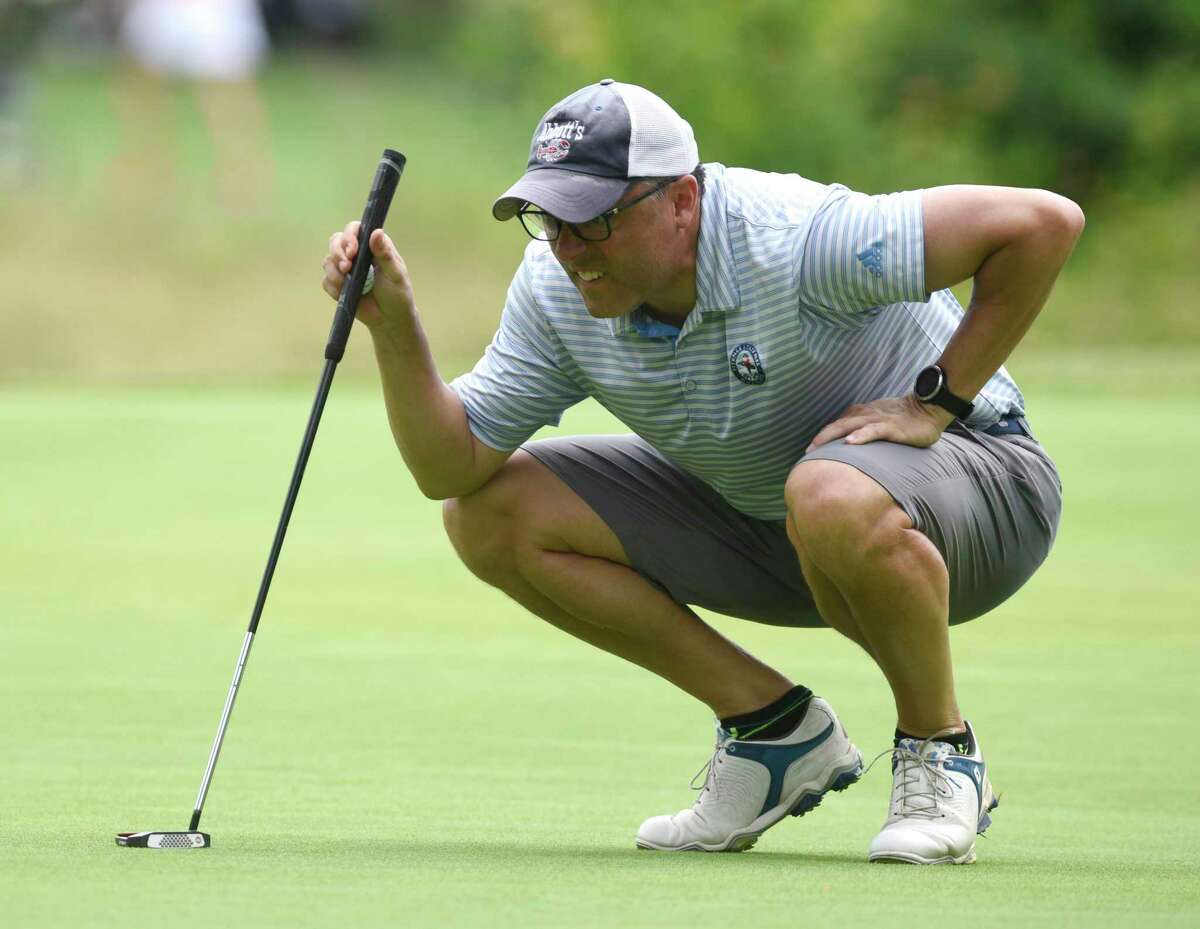Andrew McCauley lines up a putt in the 76th Annual Town Wide Men's Golf Tournament at Griffith E. Harris Golf Course in Greenwich, Conn. Sunday, June 27, 2021.