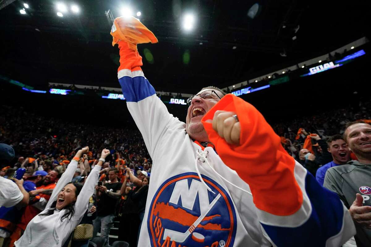 New York Islanders fans cheer after Game 6 of an NHL hockey semifinals against the Tampa Bay Lightning Wednesday, June 23, 2021, in Uniondale, N.Y. The Islanders won 3-2. (AP Photo/Frank Franklin II)