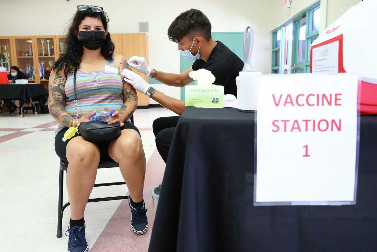 Wendy Ibarra receives her COVID-19 vaccination Friday at a clinic in Los Angeles. Los Angeles County recommended Monday that even vaccinated people resume wearing masks in indoor public settings because of the spreading delta variant of the coronavirus.