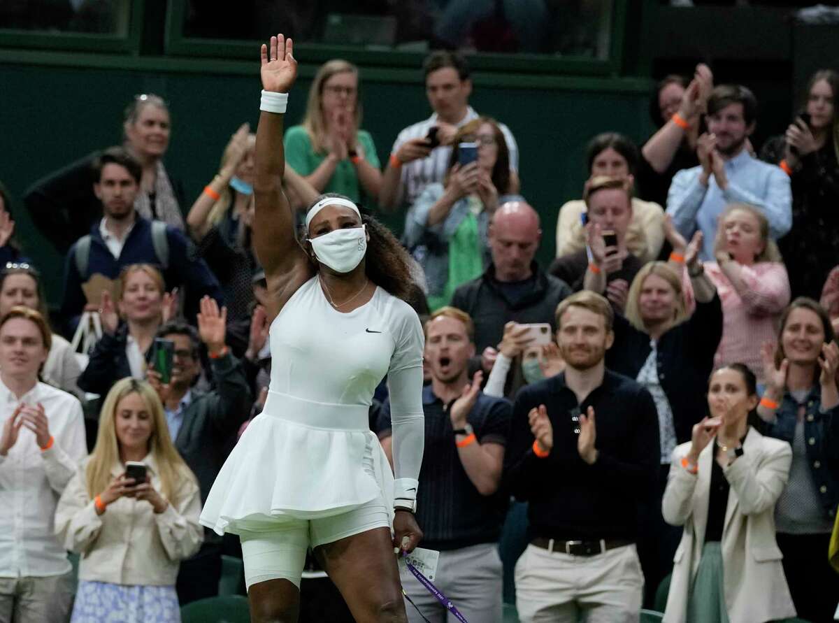 Serena Williams of the US waves as she leaves the court after retiring from the women's singles first round match against Aliaksandra Sasnovich of Belarus on day two of the Wimbledon Tennis Championships in London, Tuesday June 29, 2021. (AP Photo/Kirsty Wigglesworth)