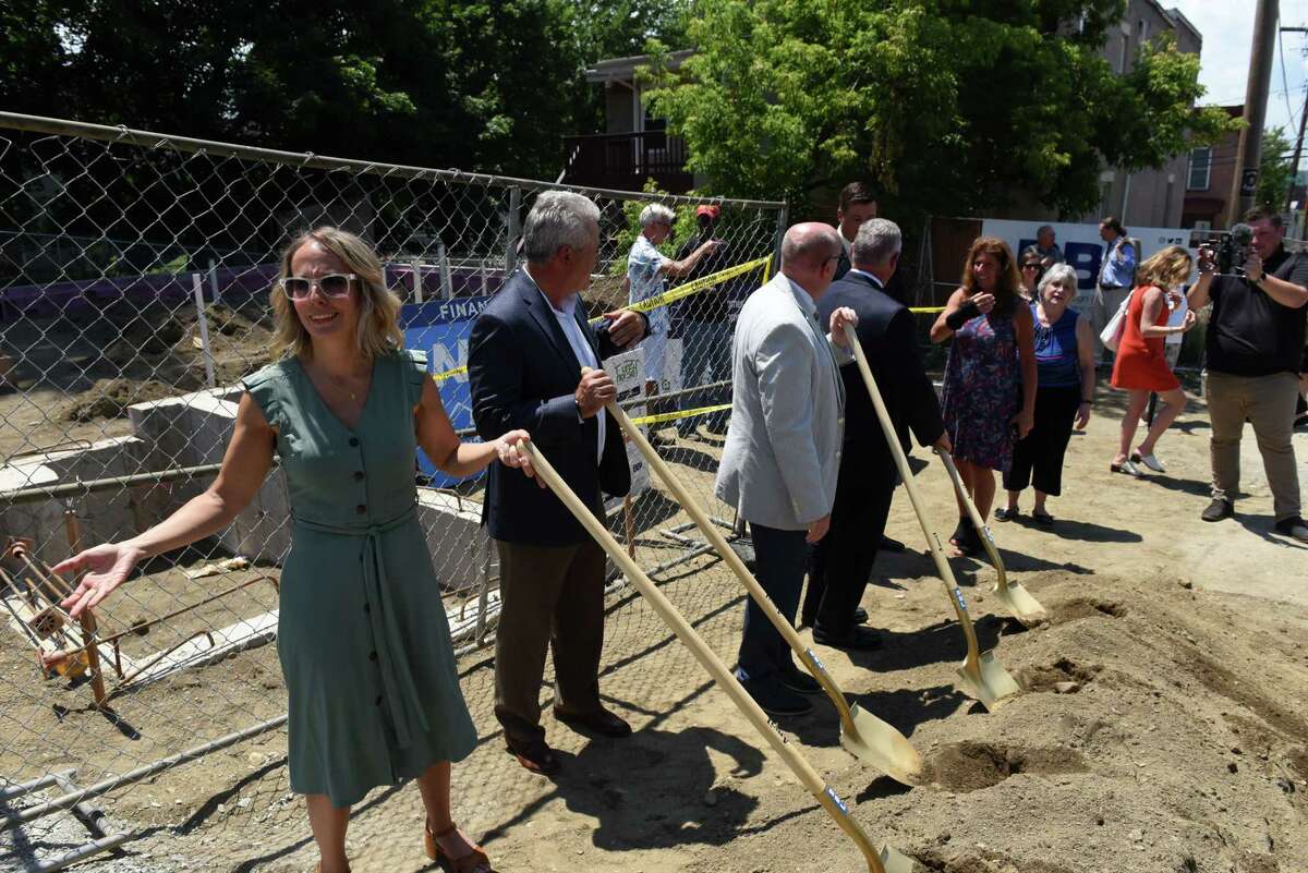 Troy Rehabilitation and Improvement Program President Christine Nealon, left, joins local dignitaries in breaking ground for the Hillside Views Neighborhood Revitalization housing program on Tuesday, June 29, 2021, outside one of the new properties on Rensselaer Street in Troy, N.Y. The housing development will consist of 51 apartments in several locations for individuals and families with 26 households to receive supportive services through Unity House. (Will Waldron/Times Union)