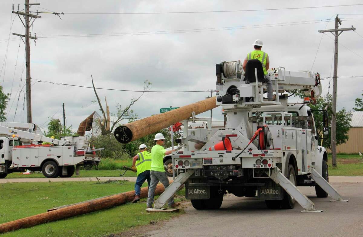 DTE lineworkers work in the field on a power line.  