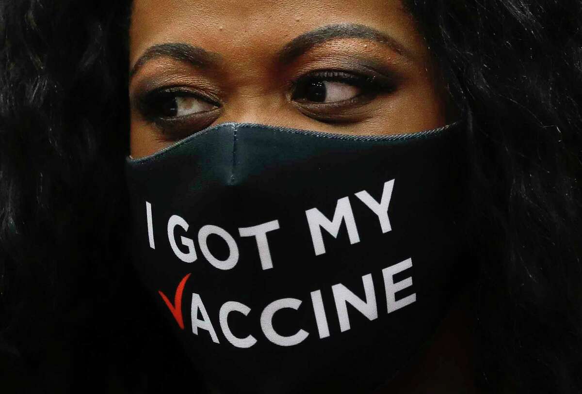 A women wears a face mask that reads “I got my vaccine” during an athletic signing ceremony at Conroe High School, Wednesday, April 28, 2021, in Conroe.