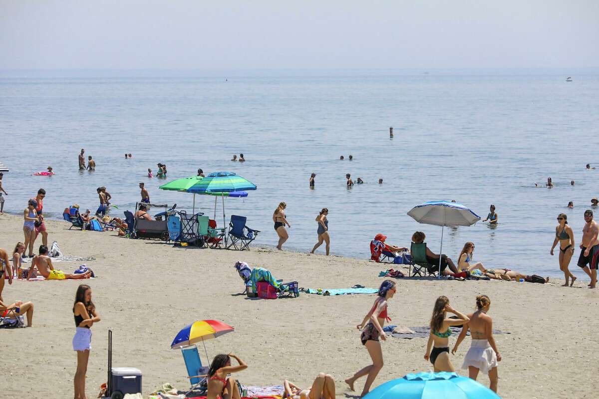 Crowds gathered Tuesday at Hammonasset Beach State Park in Madison as temperatures again rose into the 90s.
