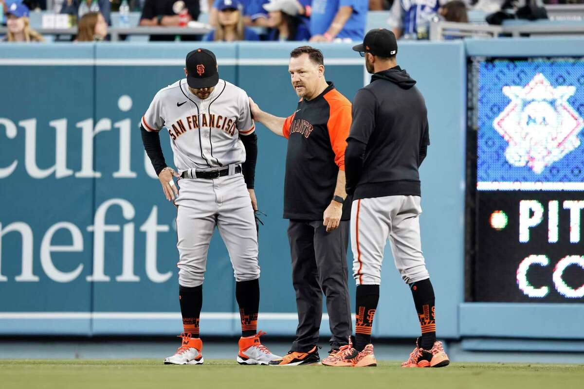 LOS ANGELES, CALIFORNIA - JUNE 29: Mike Tauchman #29 of the San Francisco Giants is checked out after his tumble in the outfield during a game against the Los Angeles Dodgers the third inning at Dodger Stadium on June 29, 2021 in Los Angeles, California. (Photo by Michael Owens/Getty Images)