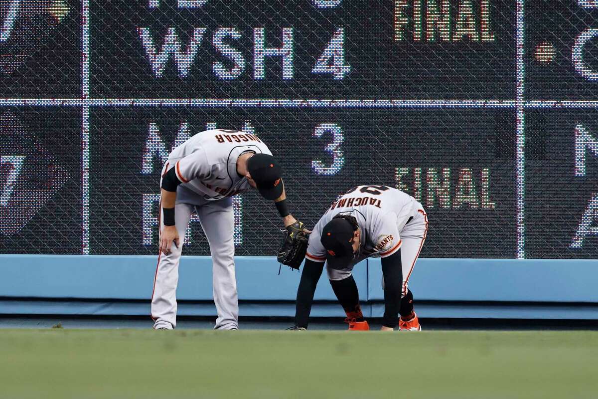 LOS ANGELES, CALIFORNIA - JUNE 29: Steven Duggar #6 of the San Francisco Giants checks on Mike Tauchman #29 of the San Francisco Giants after his tumble in the outfield during a game against the Los Angeles Dodgers the third inning at Dodger Stadium on June 29, 2021 in Los Angeles, California. (Photo by Michael Owens/Getty Images)
