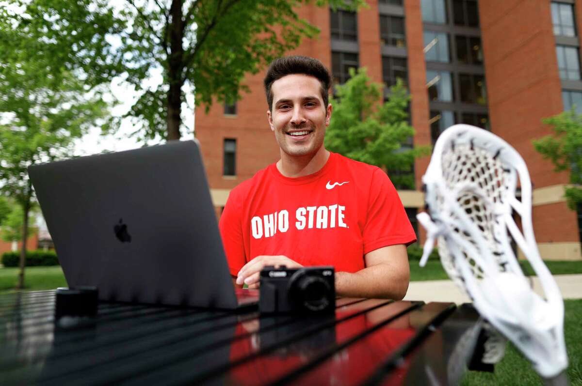 Ohio State lacrosse player Mitchell Pehlke, an aspiring YouTube personality who broadcasts a channel to 14,000 subscribers, poses for a photo outside his dorm at Ohio State University in Columbus, Ohio, on May 3, 2021. Pehlke has been cultivating his online following for years. When NCAA athletes are finally able to monetize their fame without compromising their eligibility, Pehlke is ready to restart the business of his brand.