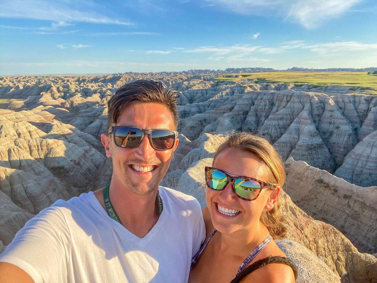 Alex Toombs (right) and her boyfriend Sam left their Bridgeport, Conn. life behind to move to Victoria Island, British Columbia and travel in a van to do so. They are pictured in Badlands National park in South Dakota. 