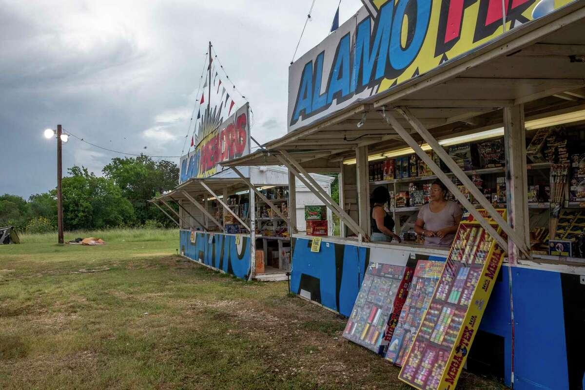 Cousins Crystal Casanova and Neiva Garcia sell fireworks at an Alamo Fireworks stand on Walzem Road.