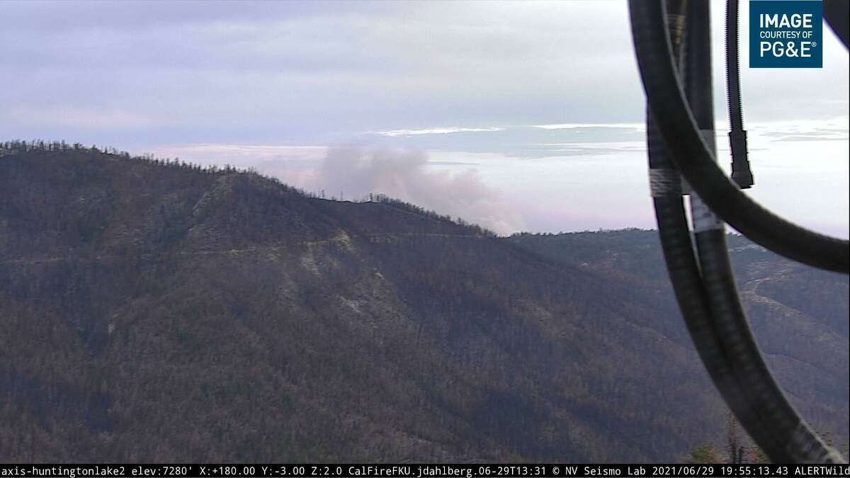 An image from a wildfire camera showing smoke from the Blue Fire burning through a southwest portion of the Sierra National Forest near the Bretz Mill campgrounds in Fresno County.