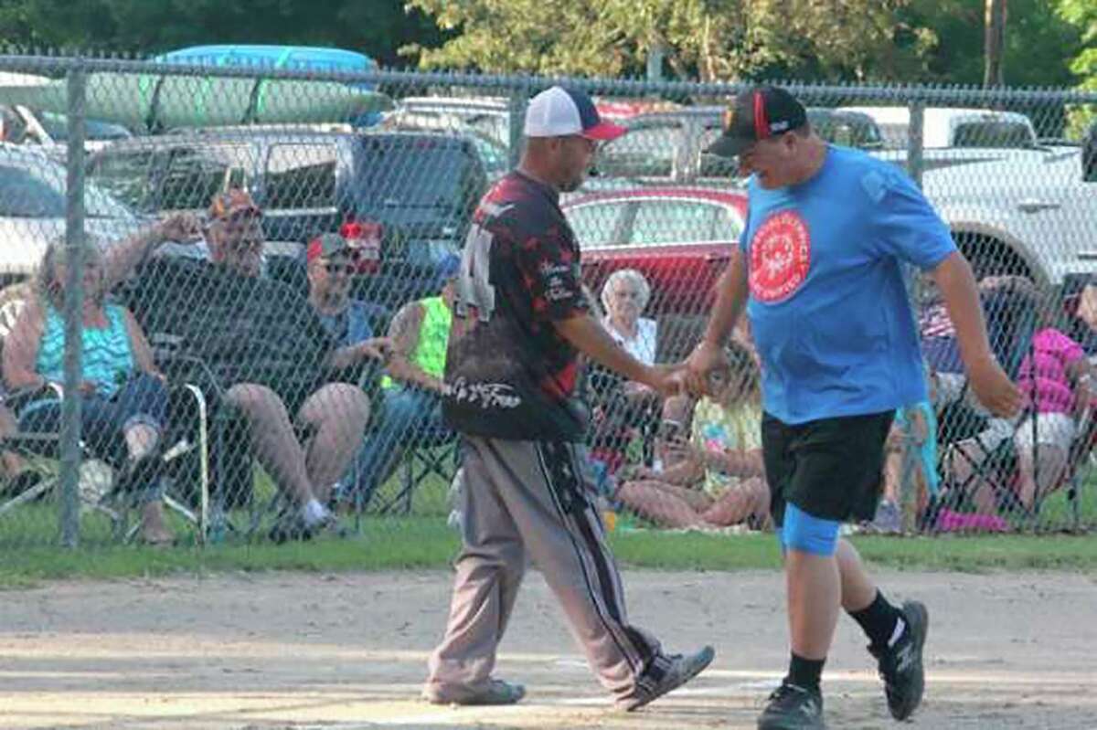 Old Timer Rob Young, right, is congratulated by Jim Haywood after belting a home run in the Old Timer's softball game in 2019. (Pioneer file photo/John Raffel)  