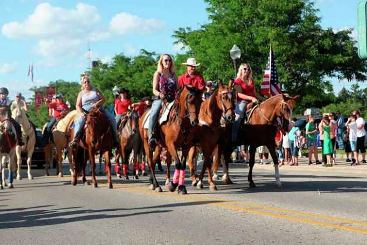 The Big Rapids Equestrian Team rides down Michigan Avenue, showing off their prized companions during the Fourth of July parade in 2017. (Pioneer file photo)