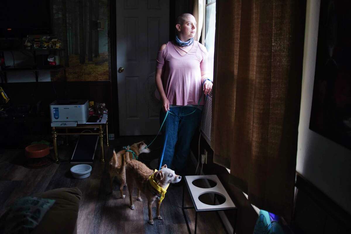 Angela Kaufman and her two rescue dogs, Mugzy and Spango, inside their mobile home at Saratoga Lakeview Mobile Home Park on Tuesday, June 8, 2021, in Saratoga, N.Y. Kaufman is facing eviction after ongoing disputes with the new owner of the park, who had agreed to allow tenants to stay on the property after he purchased it in 2021 with plans to expand his boat storage business there. (Paul Buckowski/Times Union)