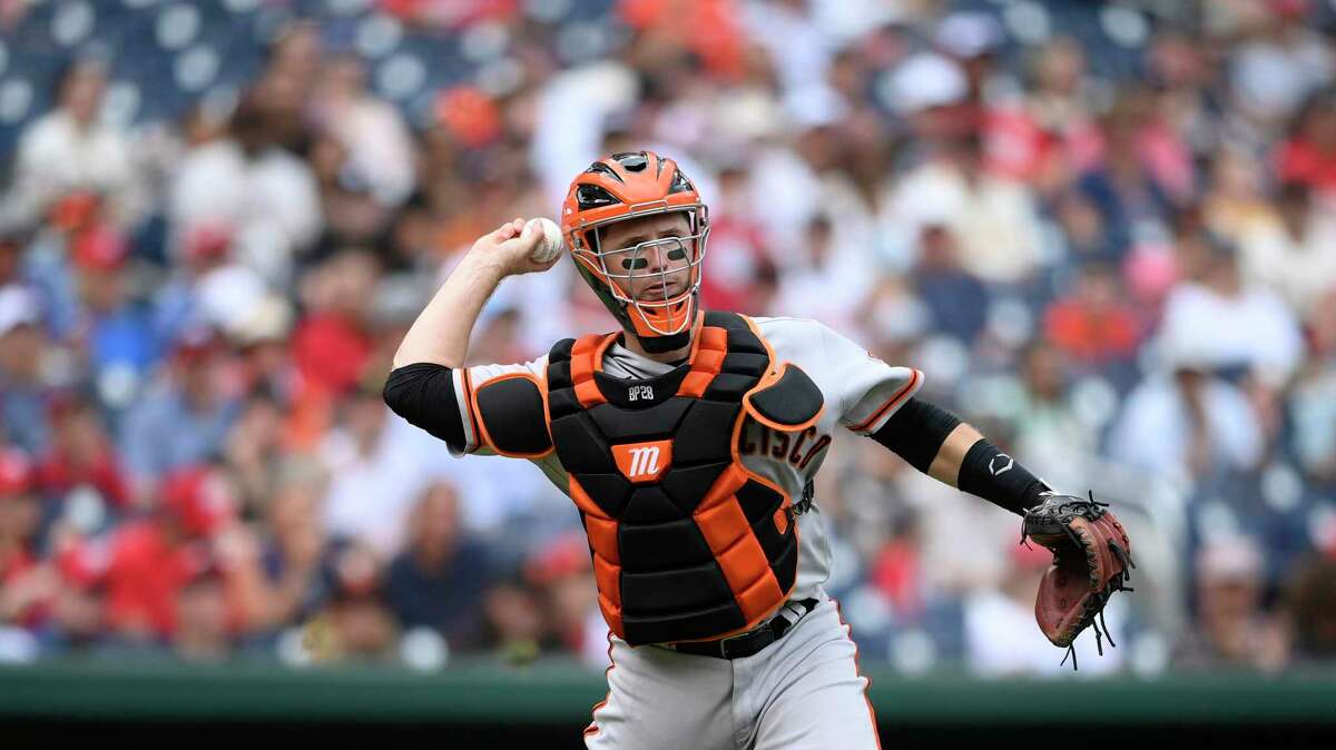 San Francisco Giants catcher Buster Posey throws to first to get out Washington Nationals' Joe Ross during the fourth inning of a baseball game, Sunday, June 13, 2021, in Washington. (AP Photo/Nick Wass)