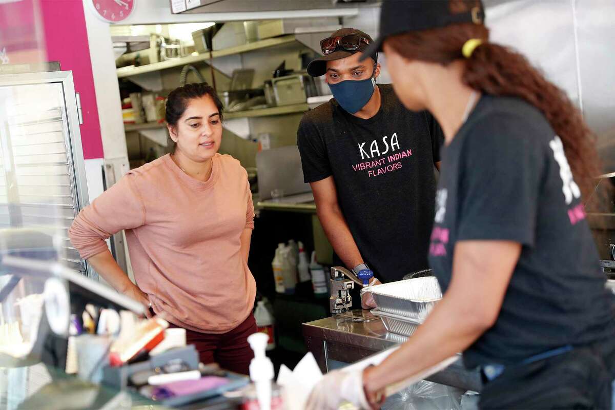 Kasa Indian Eatery owner Anamika Khanna (left) confers with Ibrahim Hornesby and his sister, Zaynab Hornesby (right) at the restaurant’s Polk Street location in San Francisco.