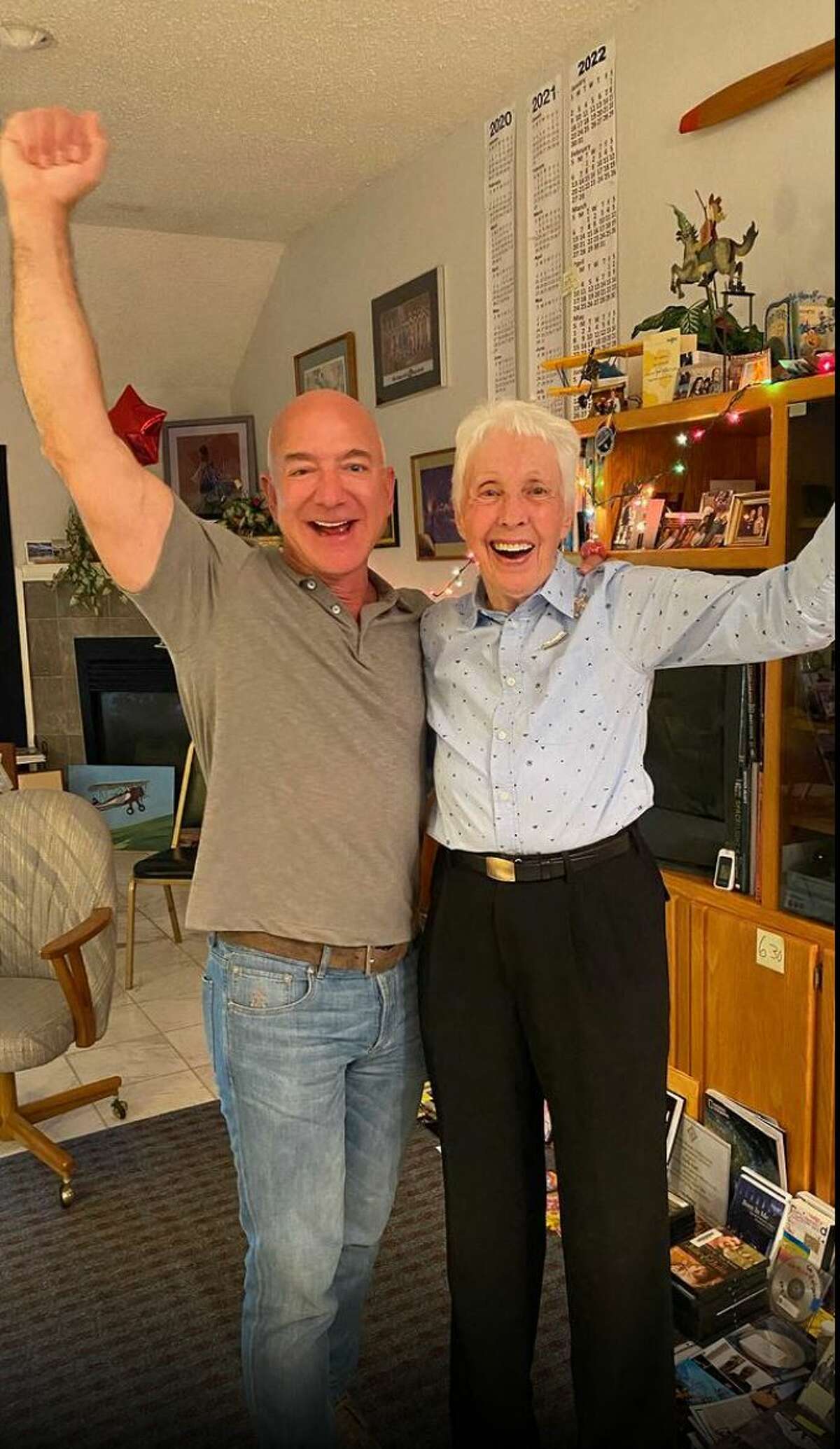 This image posted on Jeff Bezos Instagram account (@jeffbezos) and on the Blue Origin website on July 1st, 2021 shows the moment when Amazon and Blue Origin founder Jeff Bezos (L) announces to Wally Funk (R) she will fly to Space with him on the Blue Origin's New Sheppard first human flight. - Wally Funk, a 82-year-old woman pilot, will join Jeff Bezos in traveling to space this month on the first crewed spaceflight for the billionaire's company Blue Origin, the firm announced Thursday. Funk will become the oldest person ever to fly to space when she takes part in the July 20 journey aboard the New Shepard launch vehicle along with Bezos, his brother Mark and the unnamed winner of an auction for another seat on the aircraft. (Photo by - / BLUE ORIGIN / AFP) / RESTRICTED TO EDITORIAL USE - MANDATORY CREDIT "AFP PHOTO /BLUE ORIGIN" - NO MARKETING - NO ADVERTISING CAMPAIGNS - DISTRIBUTED AS A SERVICE TO CLIENTS