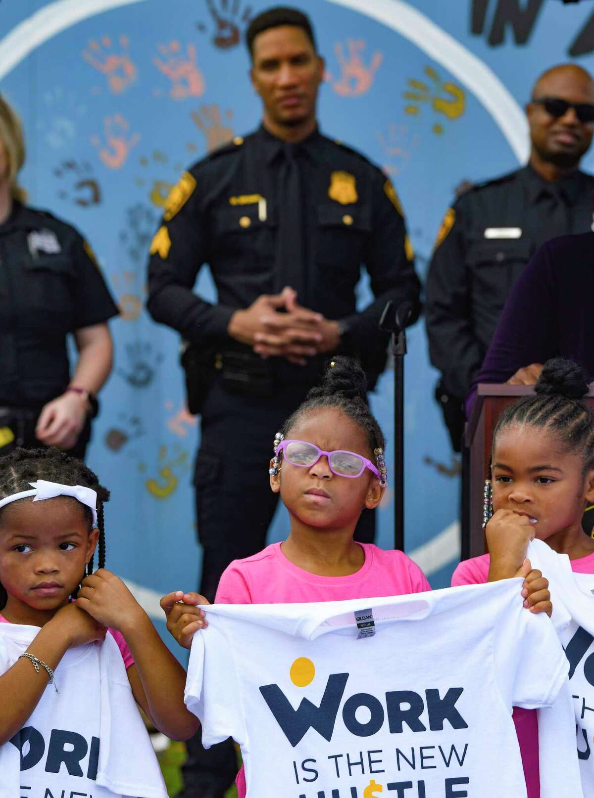 Laini Simmons, middle, and other children participate during the launch of the ‘Work is the New Hustle” program at the Eastside Boys & Girls Club on Tuesday. The program is the brainchild of Laura Thompson of The African American Network TV and aims to improve relations between Black children and police by involving the San Antonio Black Police Officers Coalition. The children are to learn life skills, such as budgeting their money.