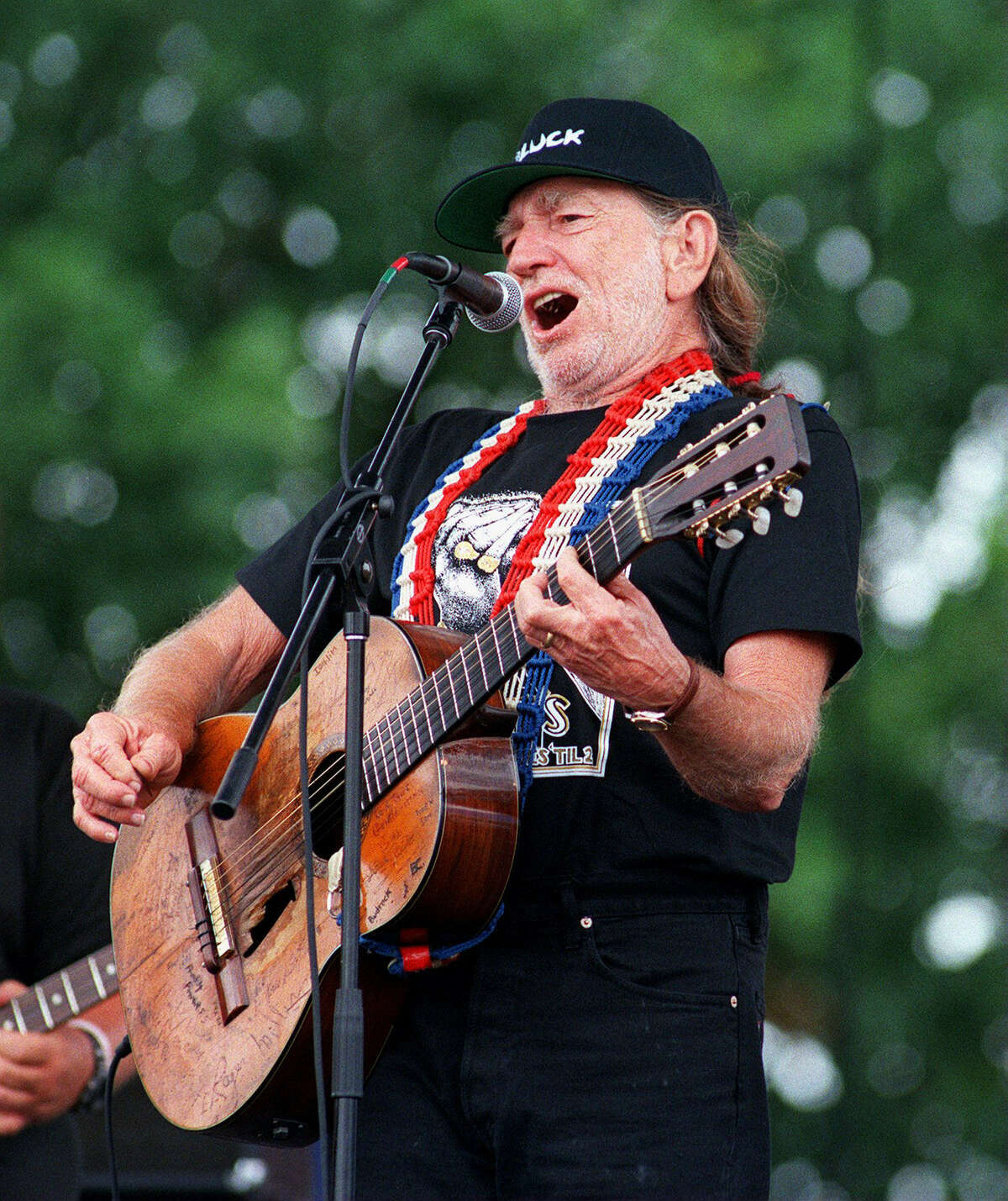 Willie Nelson belts out a tune at his Fourth of July picnic in Luckenbach, Texas in 1998.