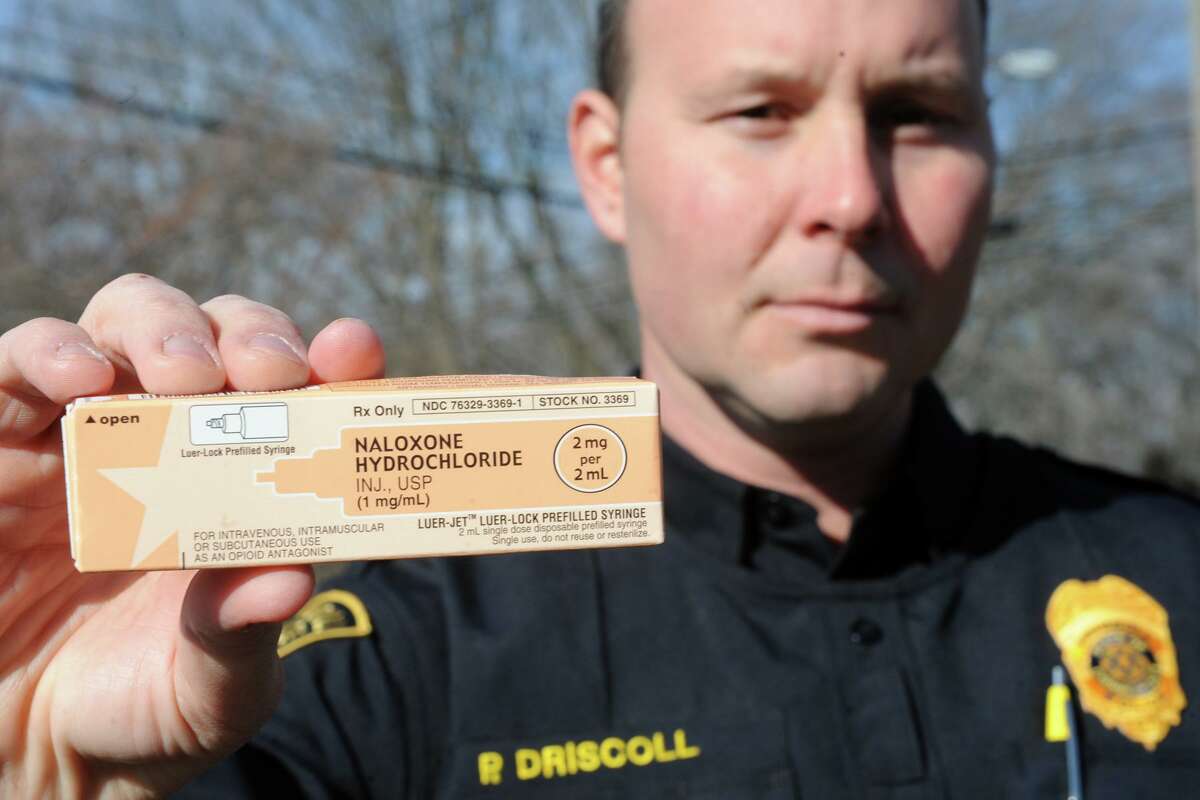 Trumbull Police Officer Paul Driscoll holds a sample of Naloxone Hydrochloride, also known as Narcan. The drug is used to reverse the effects of an opioid overdose.