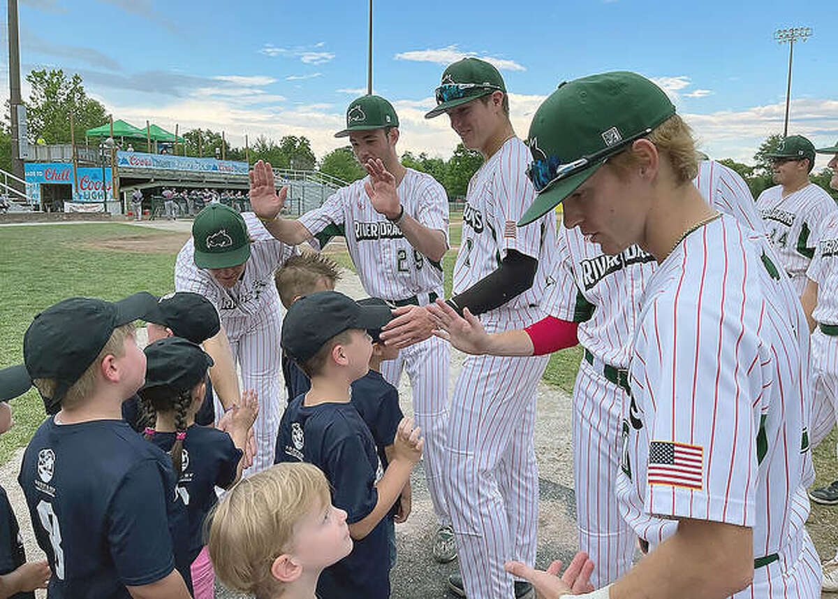 River Dragons players sign autographs for young fans prior to a game at Lloyd Hopkins Field.