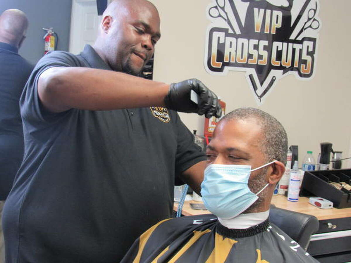 Anthony Fane works with a VIP Cross Cuts client at 2809 Homer M. Adams Parkway in Alton. Formerly an auto mechanic, Fane sold all his tools to pay for his barber college education and searched six months for the ideal location for his shop.
