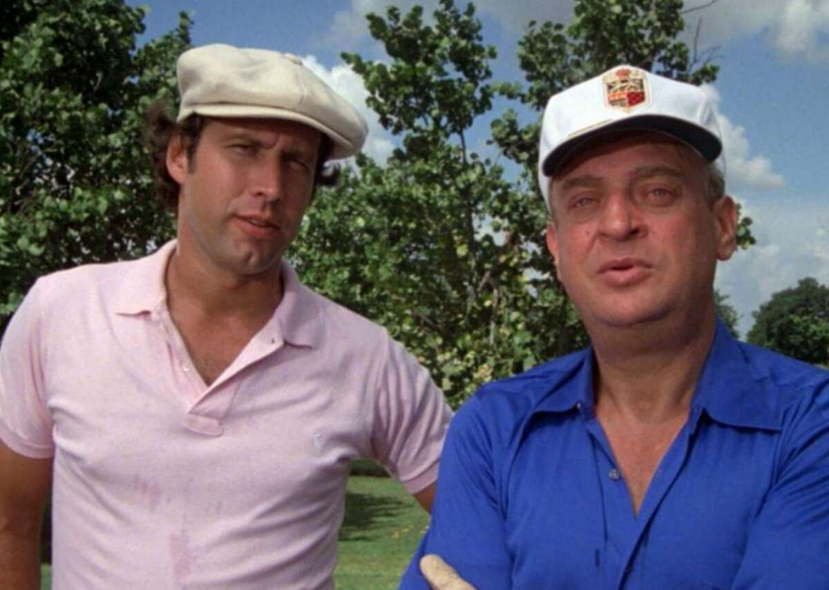 Caddyshack (1980) - Where to watch: HBO Max, Hulu - Director: Harold Ramis - IMDb user rating: 7.3 - Metascore: 48 - Runtime: 98 minutes Featuring comedic heavyweights Chevy Chase, Bill Murray, Rodney Dangerfield, and Ted Knight (among many others), the classic, often-crude slapstick “Caddyshack” was met with middling reviews upon its release. Since then, it’s enjoyed a slow burn that eventually elevated it to cult-favorite status. Roger Ebert said of the film in 1980 that it “never really develops a plot, but maybe it doesn't want to;” and suggested, “Director Harold Ramis brings on his cast of characters and lets them loose at one another.” Many of the film’s most beloved scenes were improvised, lending some credibility to Ebert’s perspectives.