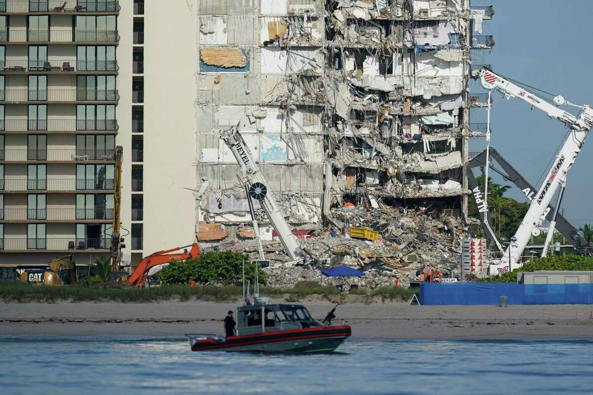 A U.S. Coast Guard boat patrols in front of the partially collapsed Champlain Towers South condo building in Surfside, Fla., which collapsed on June 24. Florida law has a 12-year limit on lawsuits, but some lawyers say the deadline may be less rigid in practice than it is on paper. The building was 40 years old.