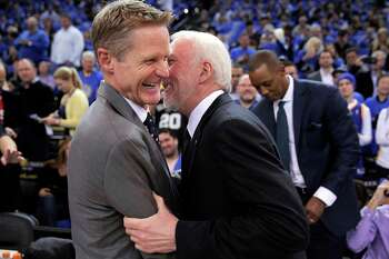 Warriors head coach Steve Kerr shares a moment with Gregg Popovich before the first half of the Golden State Warriors game against the San Antonio Spurs at Oracle Arena in Oakland, Calif., on Monday, January 25, 2016.