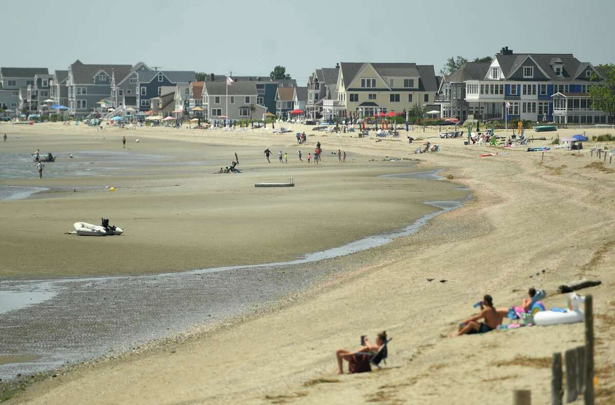 Beachgoers beat the heat at Fort Trumbull Beach in Milford, Conn. on Tuesday, June 29, 2021. Temperatures will reach the lower-90s in Connecticut on Tuesday before falling into the 60s on Wednesday, the National Weather Service said.