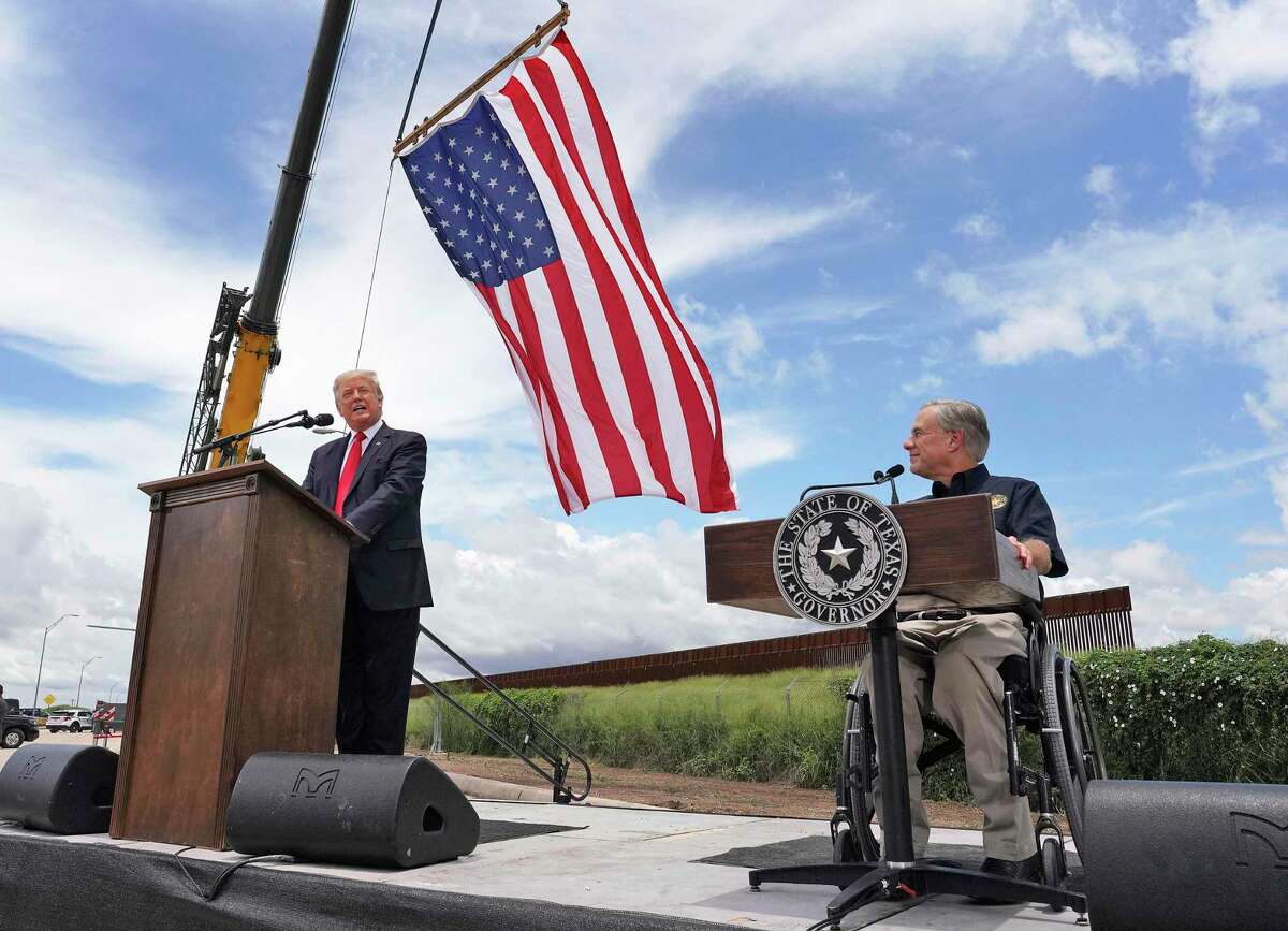 Former President Donald Trump and Texas Gov. Greg Abbott speak near a section of the border wall on Wednesday, June 30, 2021, in Pharr, Texas. (Joel Martinez/The Monitor via AP)
