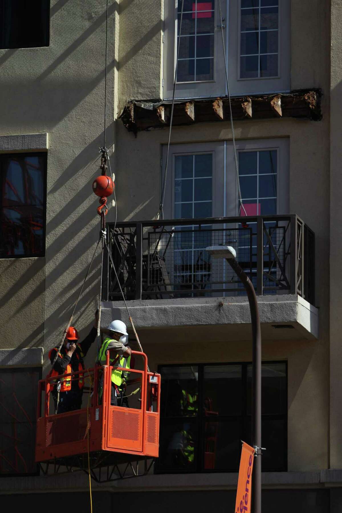 A balcony below the one that collapsed is worked on at 2020 Kittredge St. in Berkeley, California, on Tuesday, June 16, 2015.