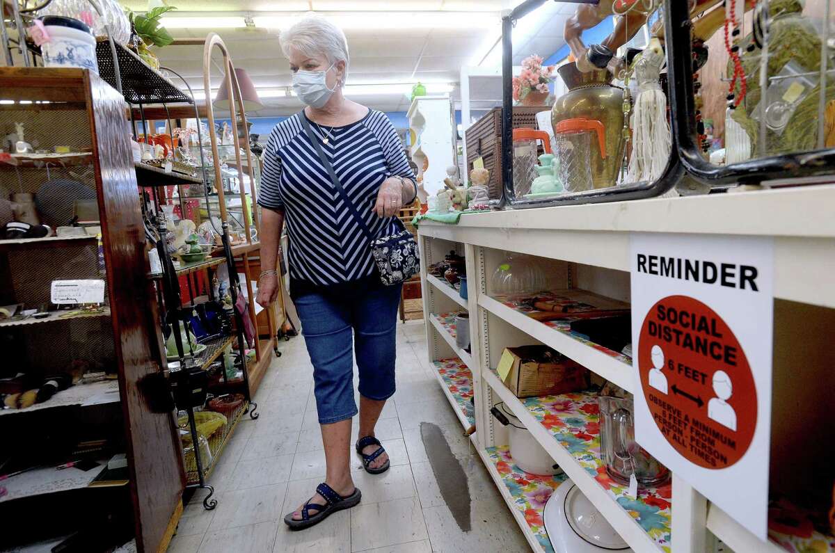 Leah Elisar, a frequent customer, peruses the vendor booths at The Antique Mall in Lumberton on its first day of reopening Tuesday. Owner Judy Carter, who also owns Country Lane Antique Mall in Lumberton, said though they were allowed to reopen May 1, she decided to wait an extra week to prepare the shop with plenty of sanitizer on hand, new vendor displays, and signage and markers placed throughout the expansive shops to remind customers of social distance protocols. Photo taken Tuesday, May 12, 2020 Kim Brent/The Enterprise