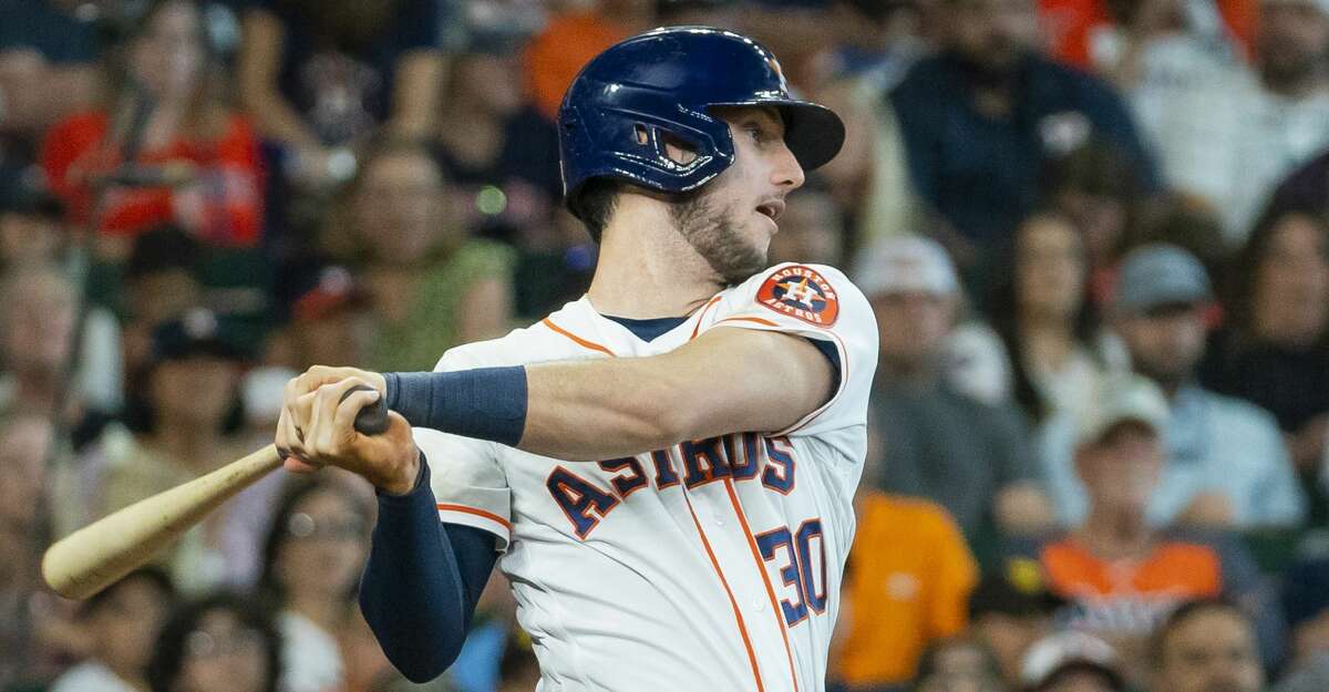 Houston Astros left fielder Kyle Tucker leans out to catch a Texas