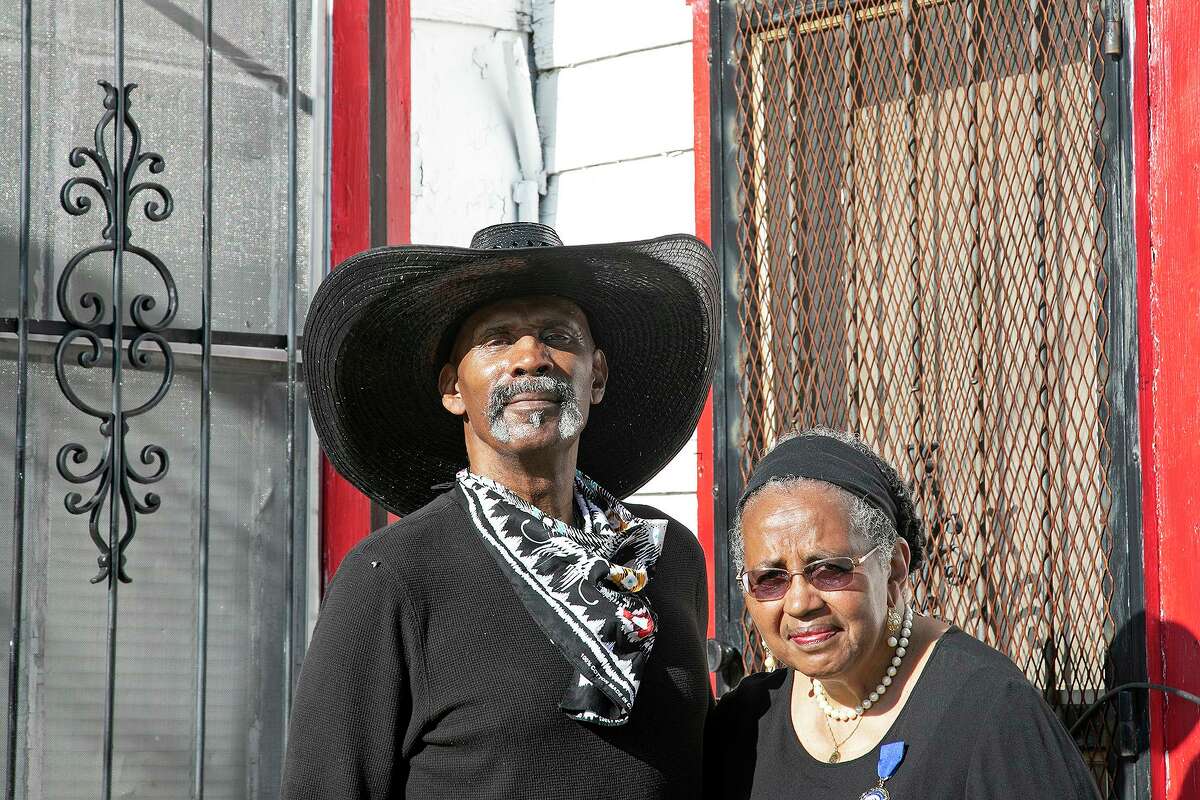 Ernest Stevenson Qadimasil II and his sister, Maria Stevenson Greene, stand outside the home where their grandparents lived with their mother in San Antonio on July 2, 2021. Their mother was born in the home in 1915.
