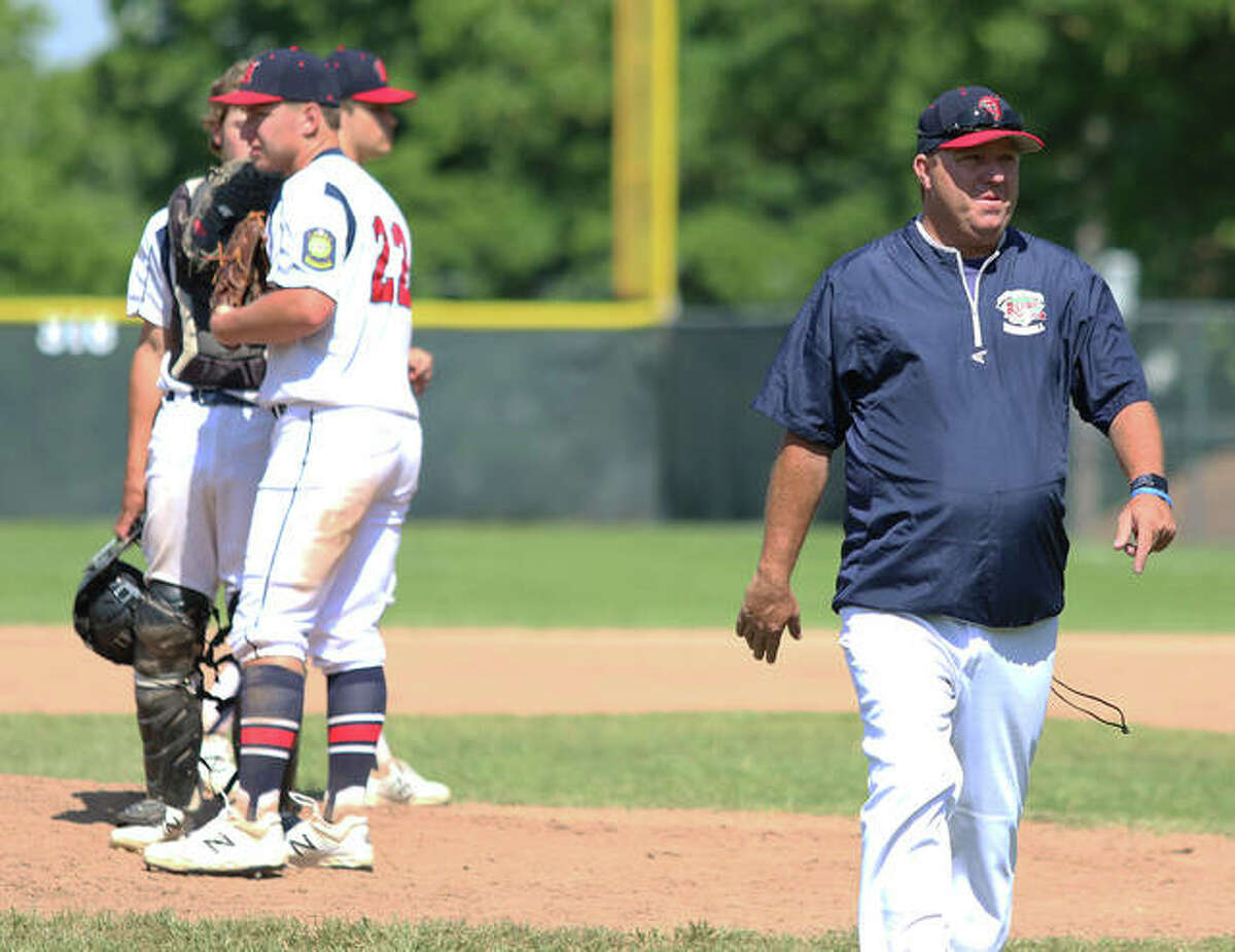 Alton Legion coach Doug Booten (right) walks back to the dugout after a mound visit during a game last summer. Post 126 is competing this weekend in the annual Firecracker Classic at Fairview Heights.
