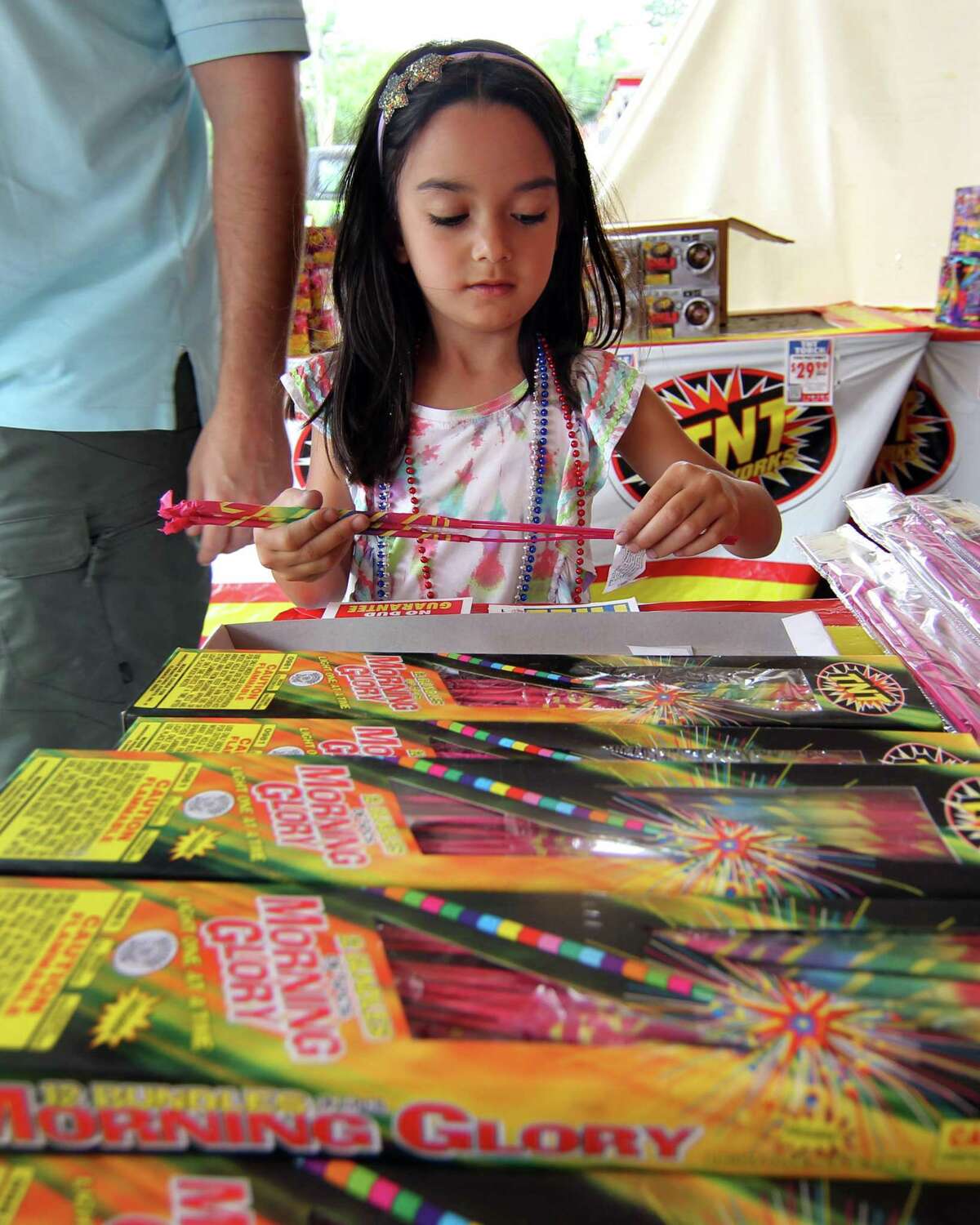 Sophia Caputo, 5, checks out sparklers as her and her dad get ready for the July 4th holiday at a TNT Fireworks tent setup at 1060 Long Ridge Road in Stamford, Conn., on Friday July 2, 2021.