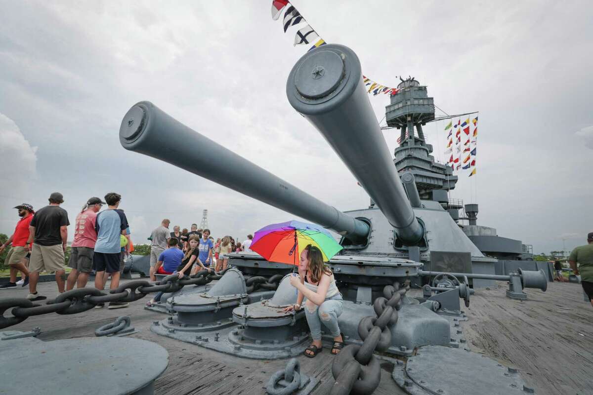 Kalin Hall, 12 yr., brought an umbrella to shield the sun and rain as she and her family visited the Battleship Texas Saturday, July 3, 2021, in La Porte.