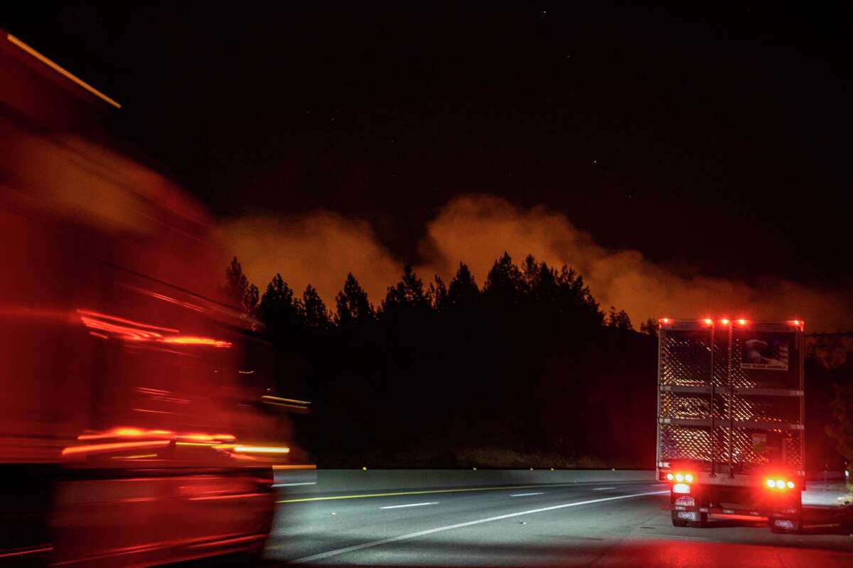 The Salt Fire burns in the mountains as vehicles drive along Interstate 5 near Lakehead (Shasta County) last week.