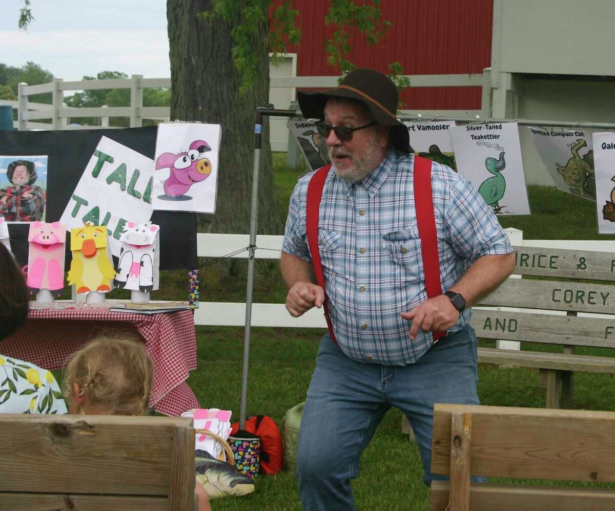 With much energy, Farmer Funn was recently a guest storyteller at the Evart Community Library. (Herald Review photo/Cathie Crew)