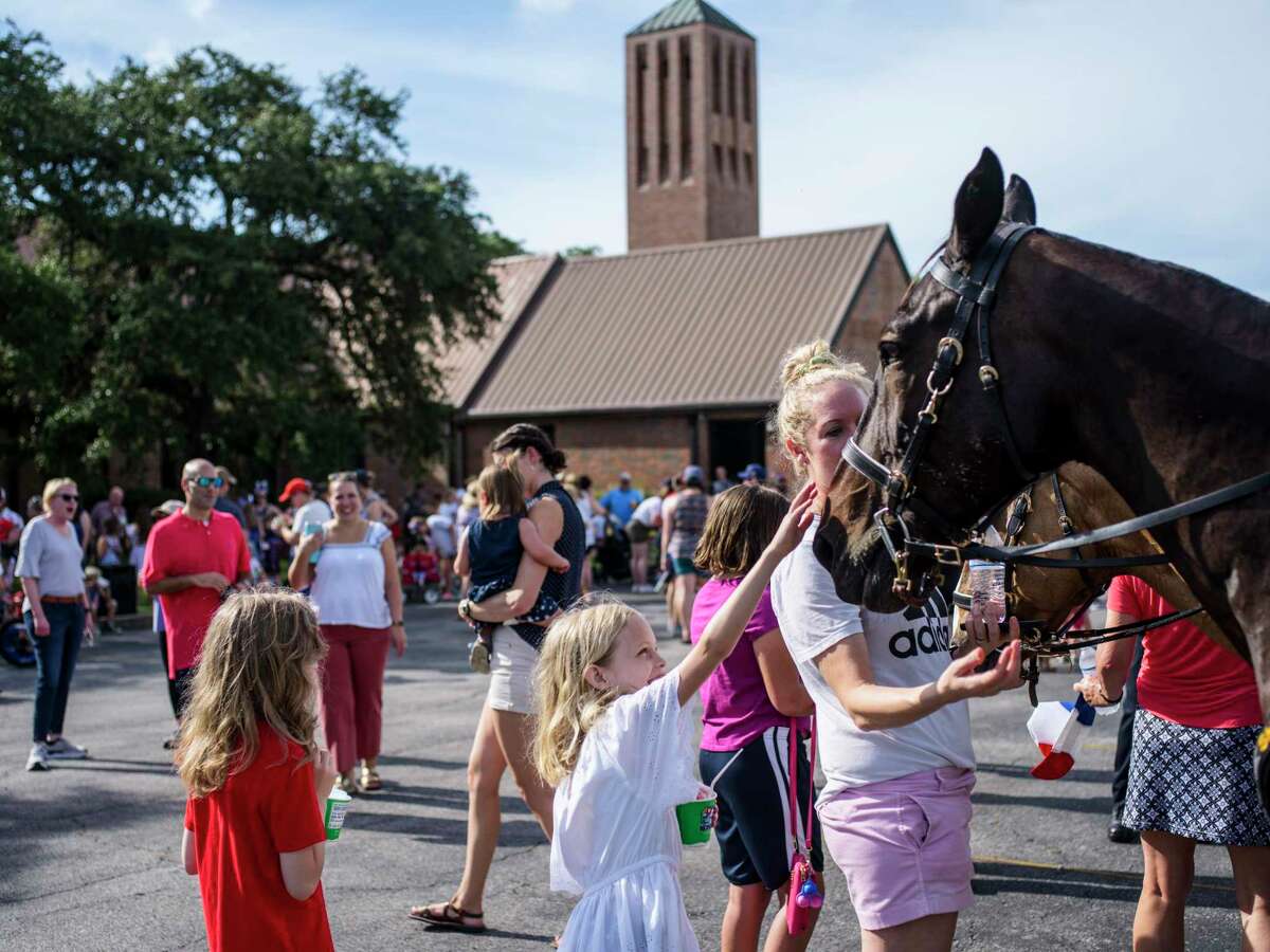 Community members start down the street during the Oak Park-Northwood parade celebrating the Fourth of July on Saturday, July 3, 2021. The parade started at the Northwood Presbyterian Church.