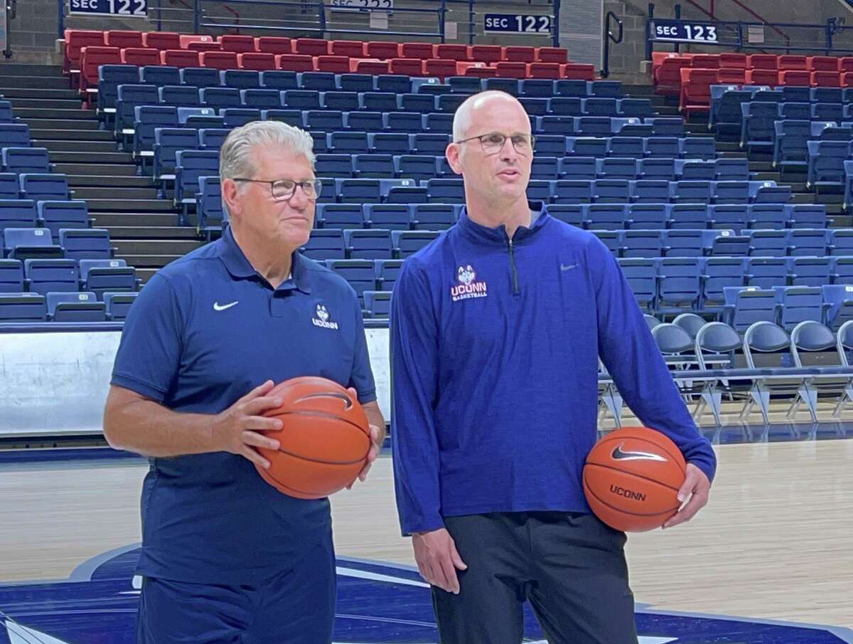 UConn basketball coaches Geno Auriemma (left) and Dan Hurley film a public service announcement in Gampel Pavilion on June 9, 2021. The two teams will play in Portland, Ore., over Thanksgiving weekend in tournaments to honor Nike co-founder Phil Knight.