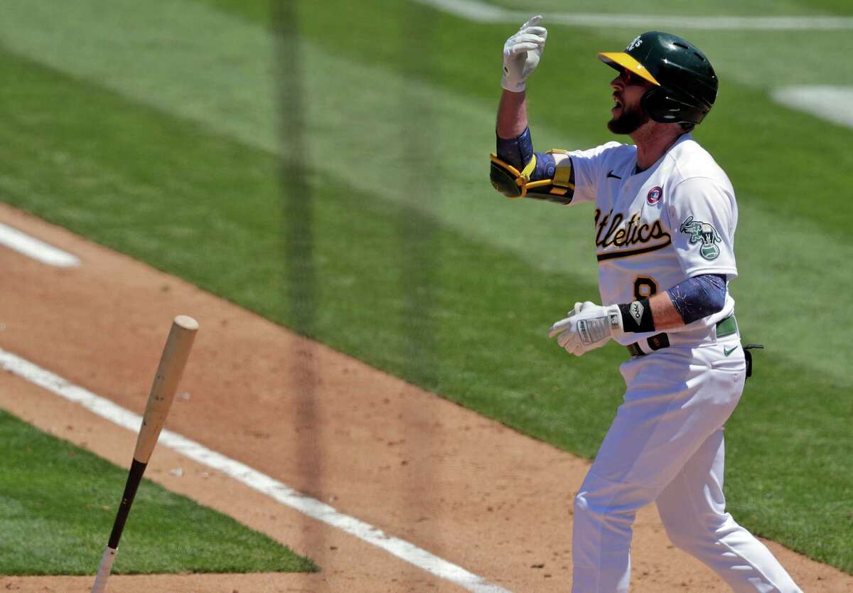 Jed Lowrie (8) reacts to being called out on strikes in the fourth inning as the Oakland Athletics played the Boston Red Sox at the Coliseum in Oakland, Calif., on Sunday, July 4, 2021.