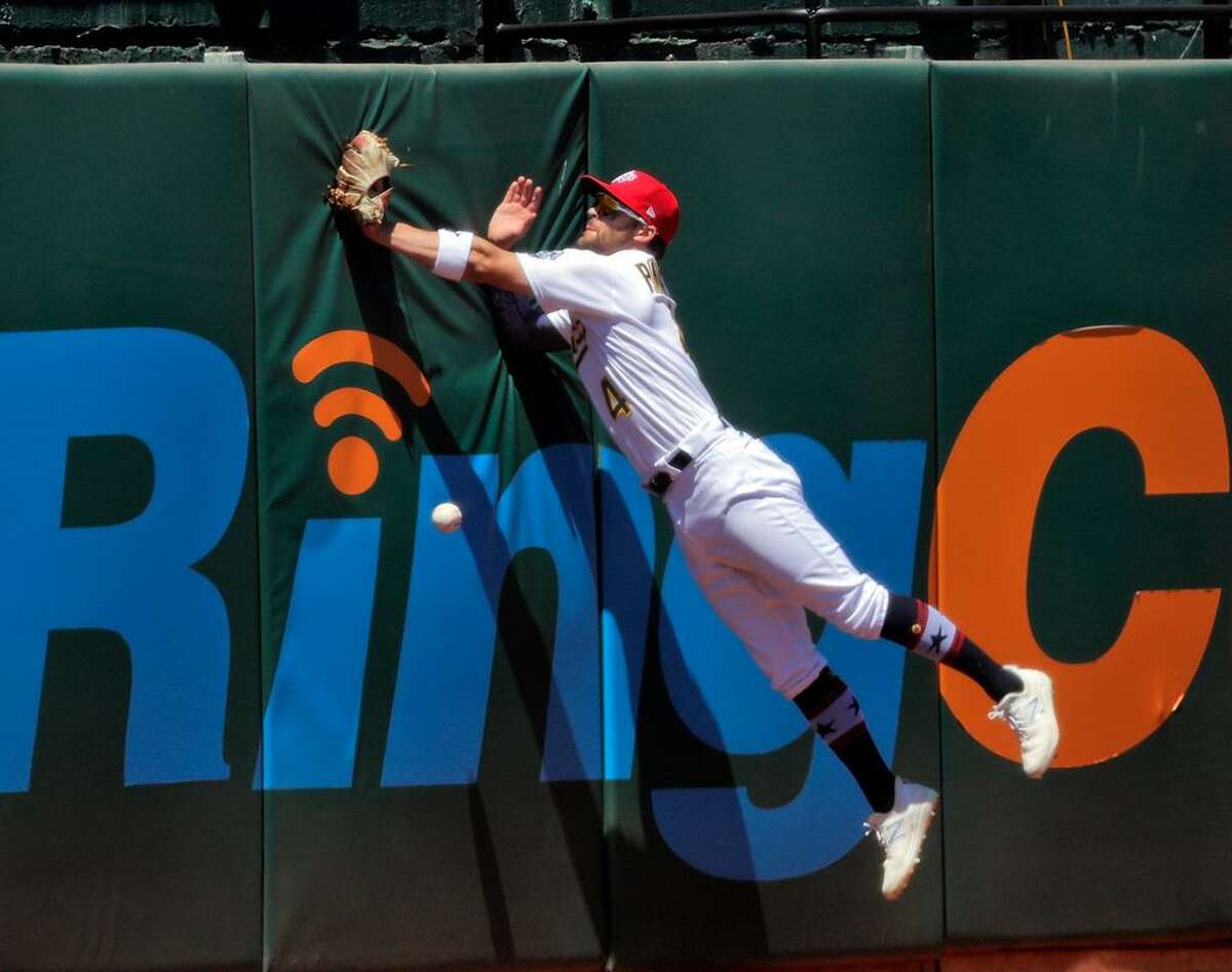 Chad PInder (4) leaps against the wall but cant get to a ball hit by. Alex Verdugo (99) in the sixth inning as the Oakland Athletics played the Boston Red Sox at the Coliseum in Oakland, Calif., on Sunday, July 4, 2021.