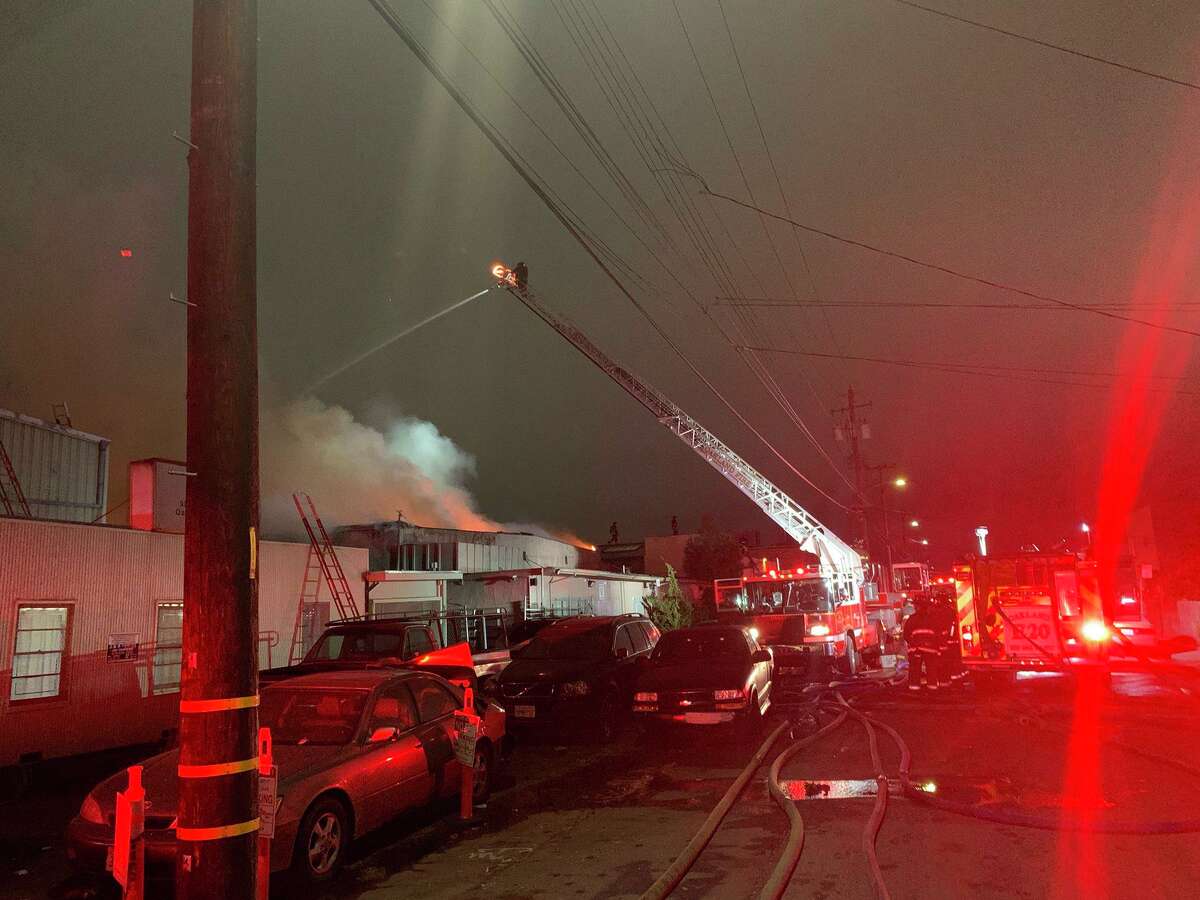 Firefighters battle a blaze at a warehouse at the 900 block of 77th Avenue in East Oakland.