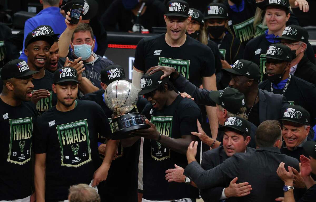 Jrue Holiday, holding the Eastern Conference Finals trophy, and the Bucks are crashing the NBA Finals party along with the Suns.