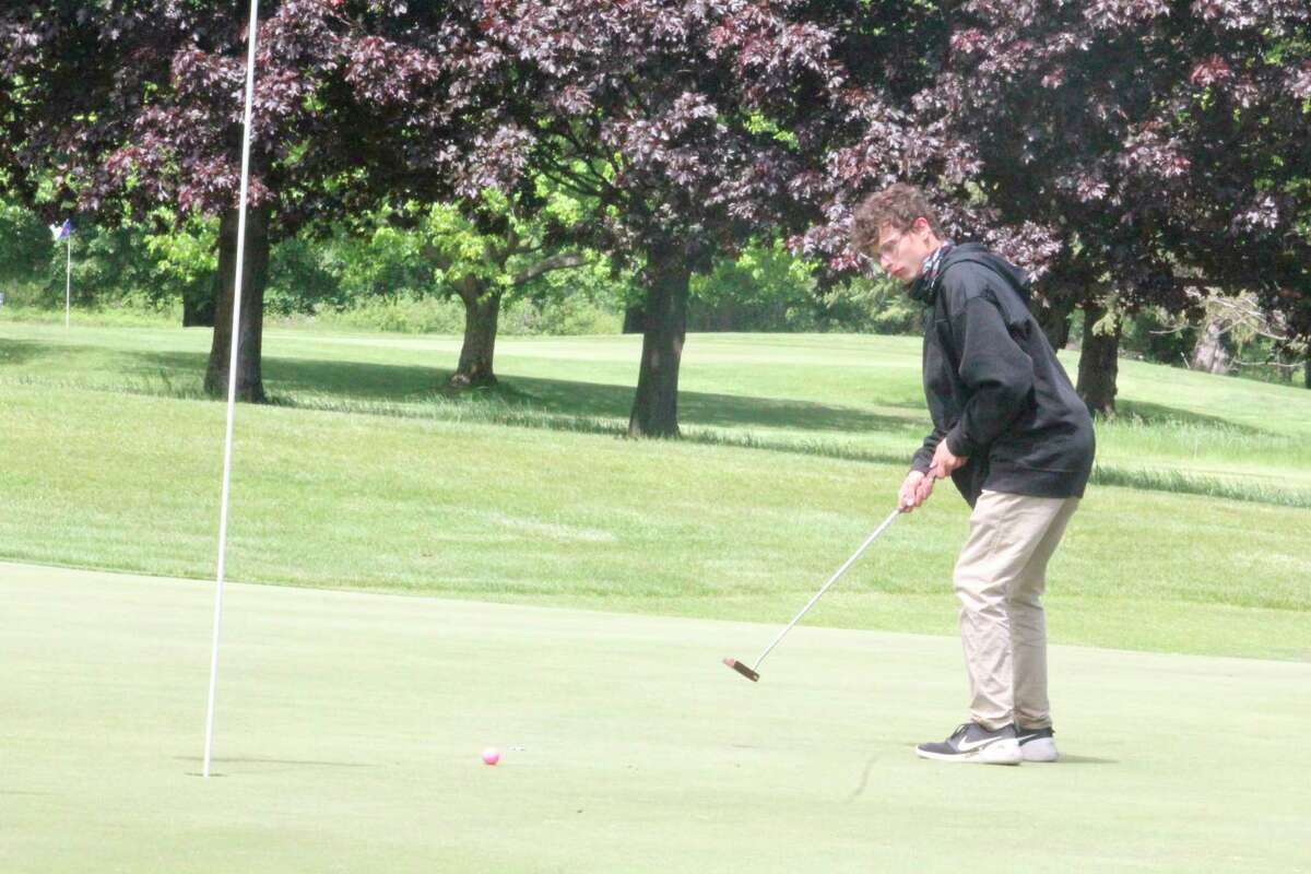 Reed City's Michael Perri watches his putt at Katke Golf Course during the 