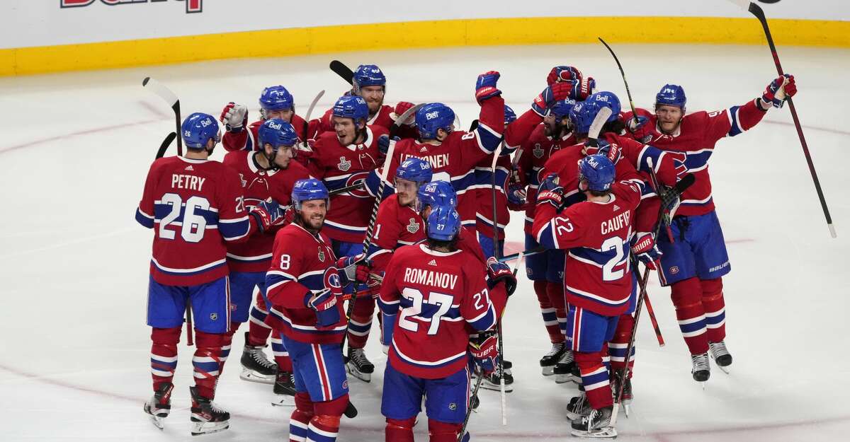 The Montreal Canadiens celebrate their 3-2 win during the first overtime period against the Tampa Bay Lightning in Game Four of the 2021 NHL Stanley Cup Final at the Bell Centre on July 05, 2021 in Montreal, Quebec, Canada. (Photo by Mark Blinch/Getty Images)