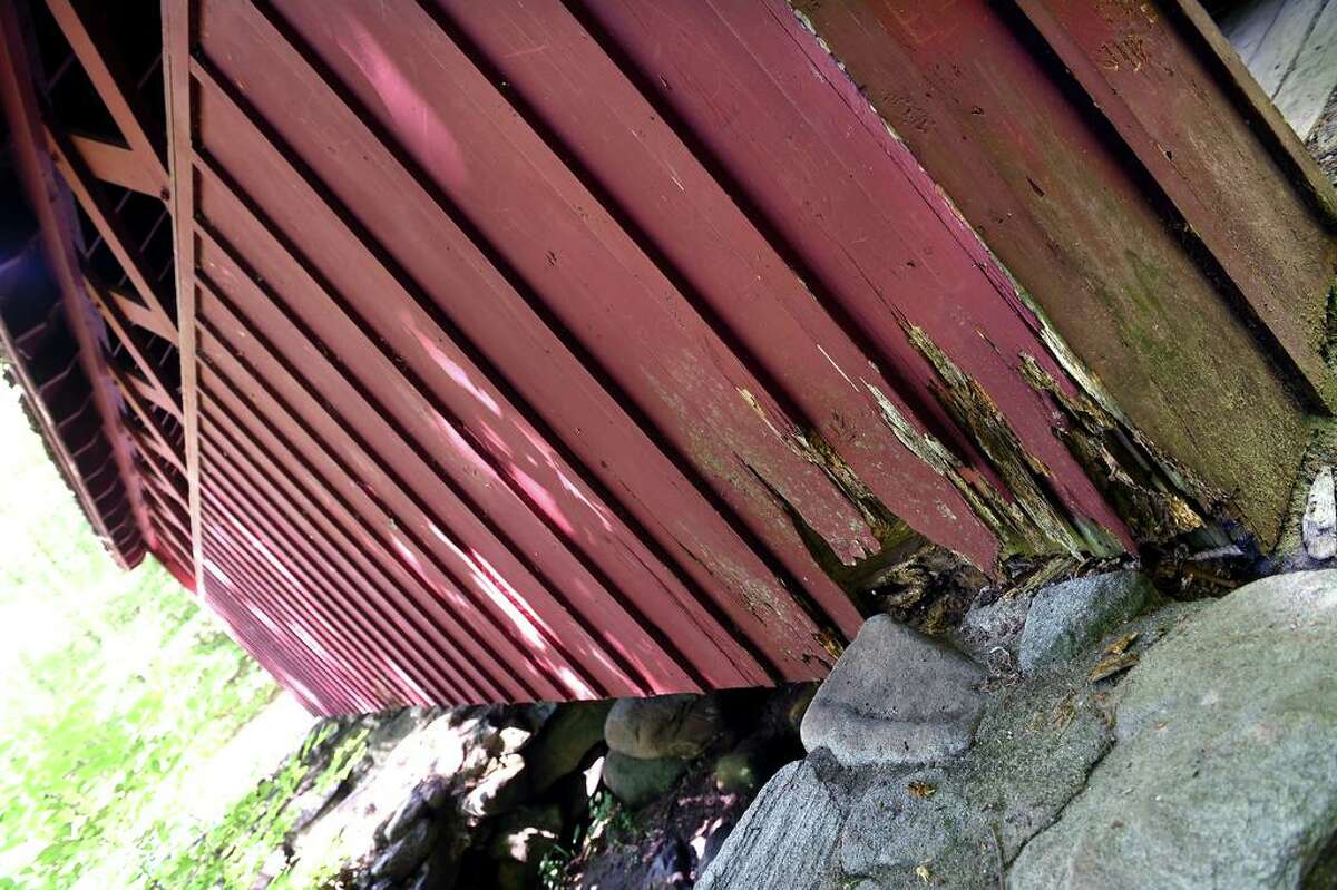 Rotting wood is visible on the covered bridge in Chatfield Hollow State Park in Killingworth on June 30.