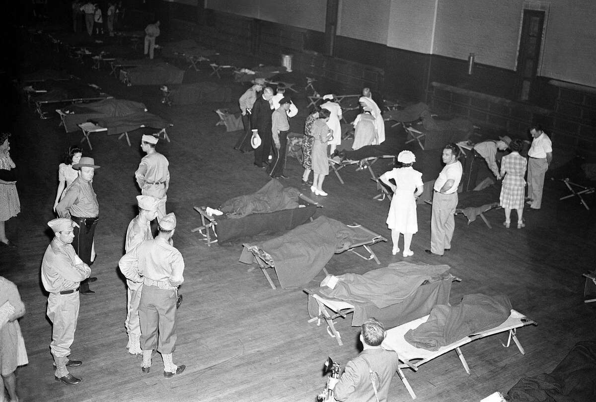 This July 6, 1944, file photo shows a scene at the armory where bodies were brought in the aftermath of a fatal circus fire in Hartford, Conn.